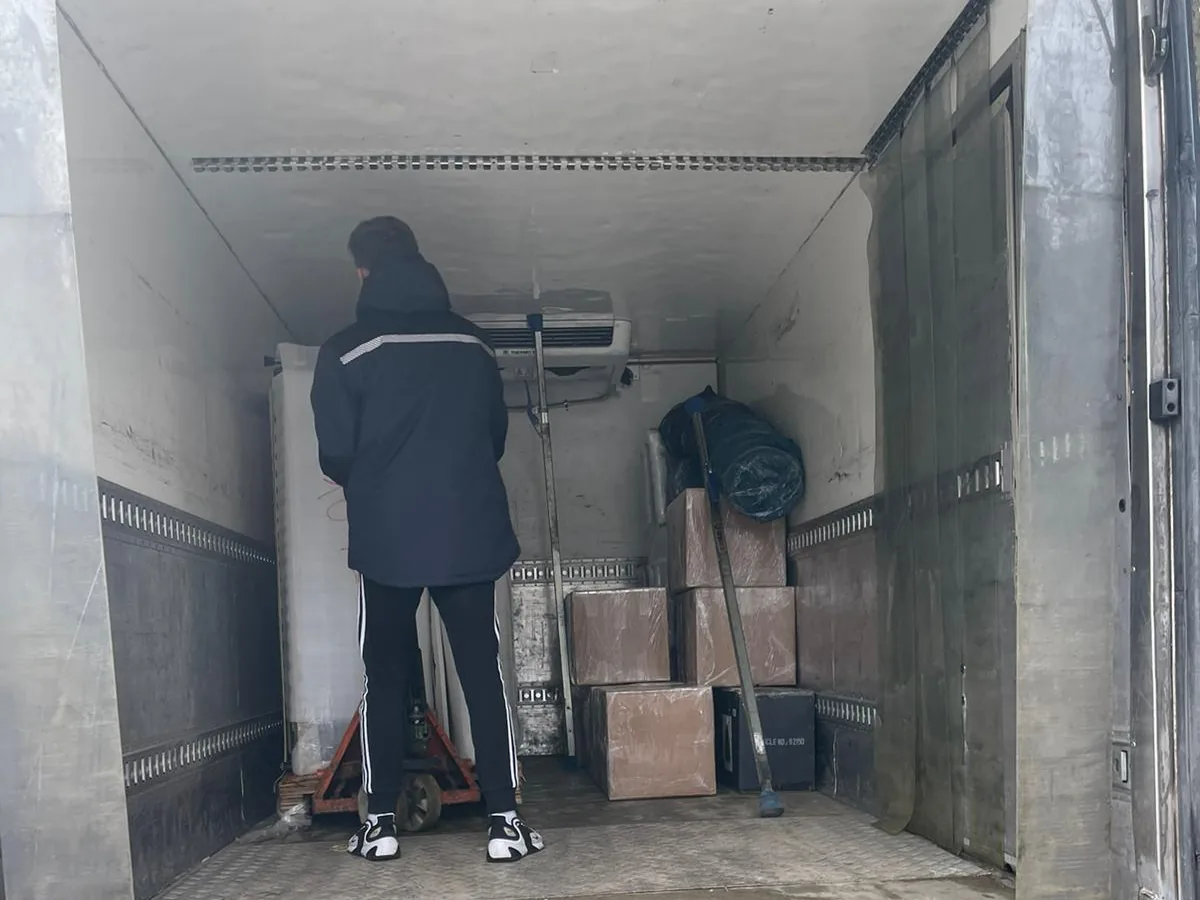 Boxes and a pallet jack in the box truck
